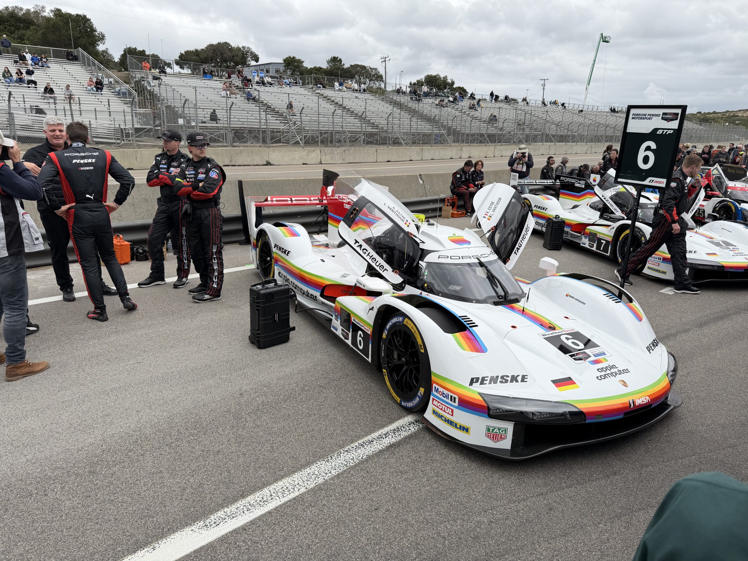 Slightly modified image of the Porsche race car at IMSA Laguna Seca with some of the crew removed from the picture.